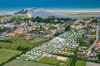 Aerial photo of Øster Hurup Camping with caravans, tents, and pool near the beach.