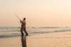 Man fishing at sunset near Vedersø Strand Camping.