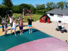 Children playing on a bouncy cushion and go-kart near the playground at Nissum Fjord Camping.