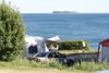 Caravans and tents with sea view at Blushøj Camping, Ebeltoft.