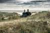 Couple sitting and watching the sea from the dunes near Vedersø Strand Camping.