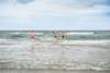 Group of people swimming in the sea near Vedersø Strand Camping.
