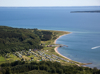 Luftfoto af Rosenvold Strand Camping ved Vejle Fjord med skov og strand.
