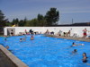 Guests enjoying a sunny day in the campsite’s outdoor swimming pool.